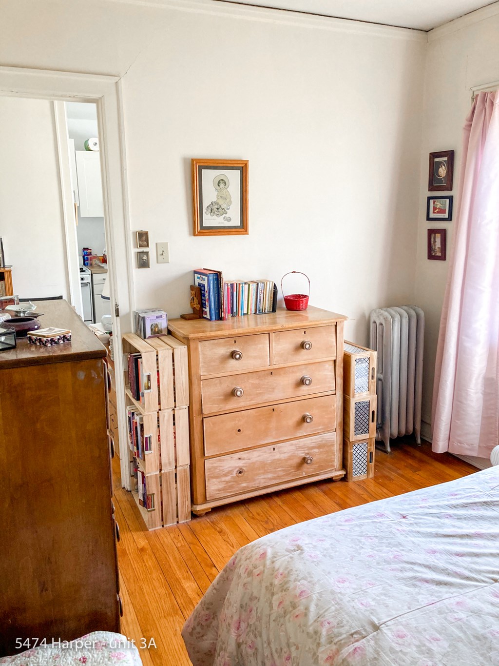 a bedroom with a dresser and a bed in it