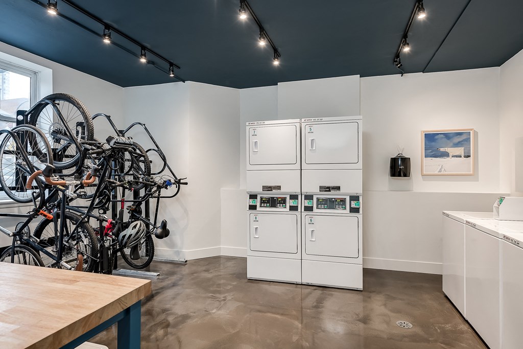 a kitchen with a bunch of bikes on the wall