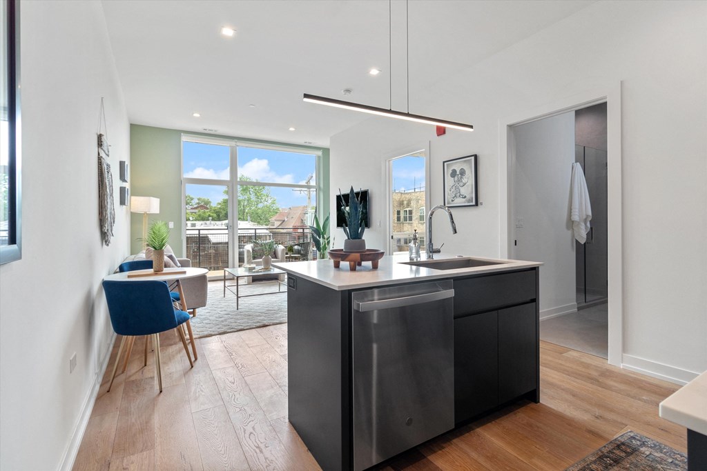 a kitchen with a large island in the middle of a living room