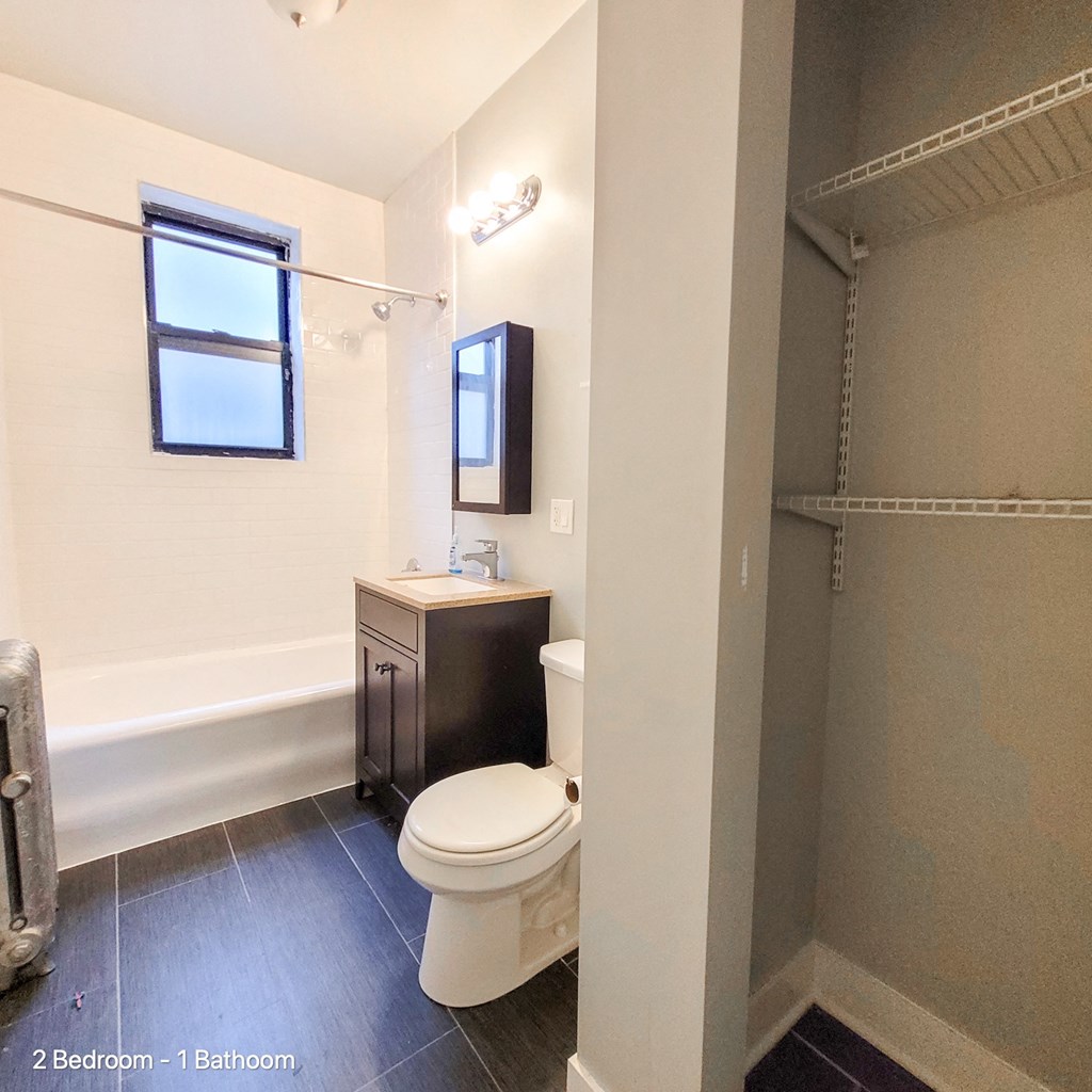 a bathroom with a toilet and a shower and a sink