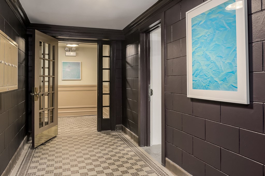 a hallway with doors and a painting on the wall