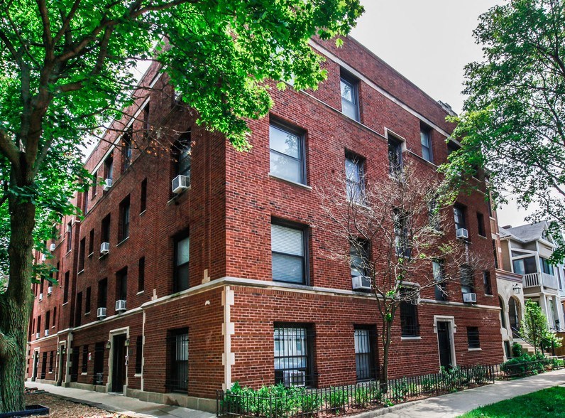 a red brick building with trees in front of it