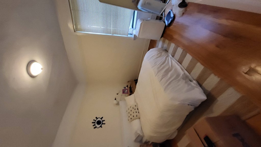 a small room with a bed and a window