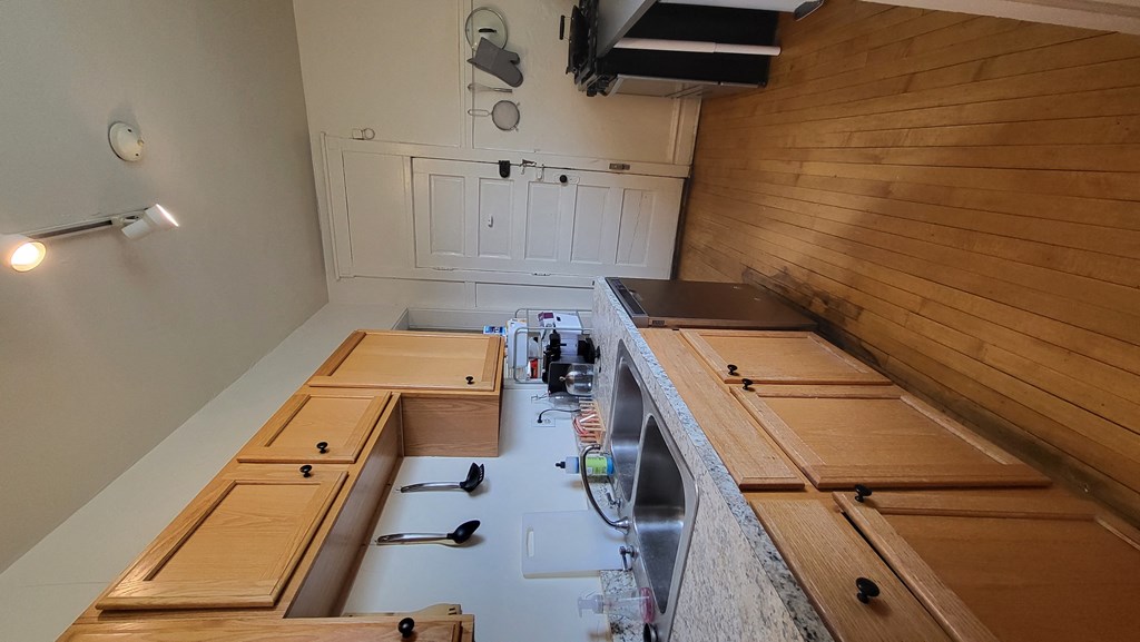 a view of the kitchen from the top of the stairs