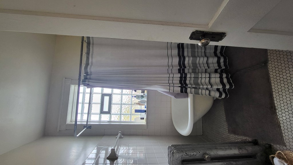 a bathroom with a sink a toilet and a window