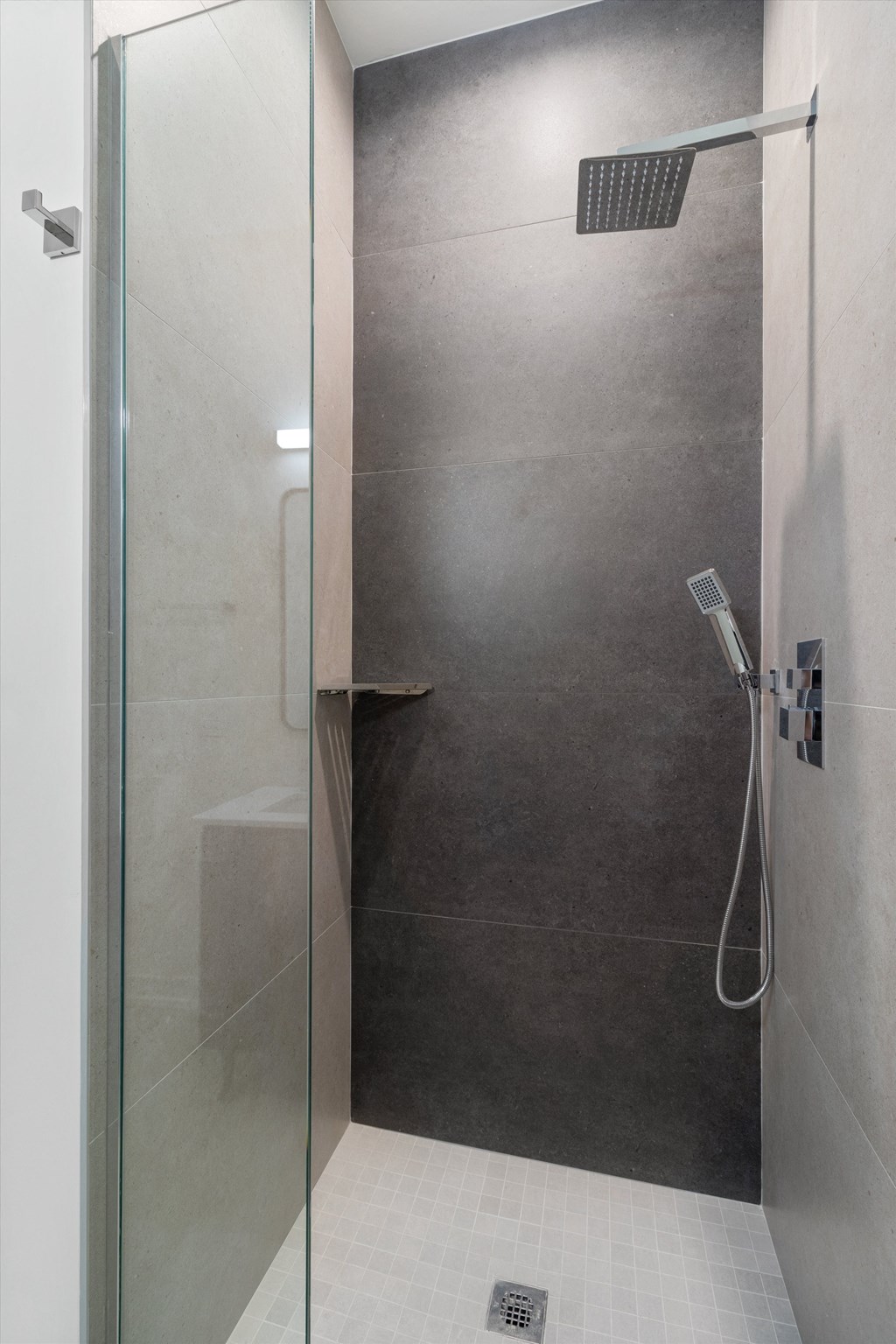 a bathroom with a shower and a glass door