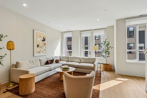 A living room with a large sectional sofa and a coffee table.