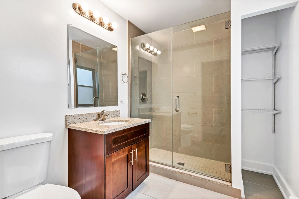 a bathroom with a shower and a sink and a mirror
