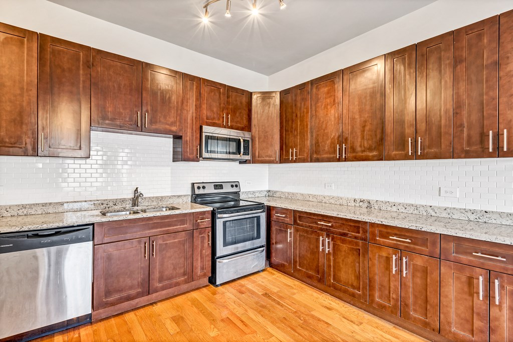 a kitchen with wooden cabinets and stainless steel appliances