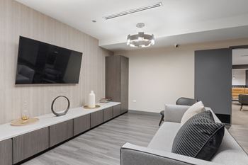 a living room filled with furniture and a flat screen tv