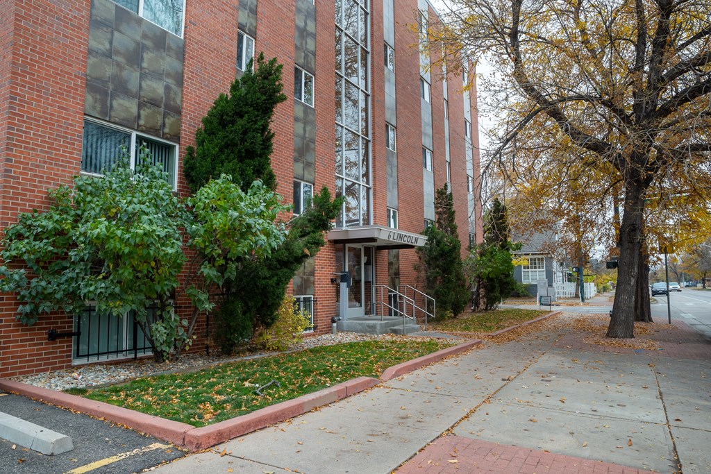 a red brick building with a sidewalk in front of it