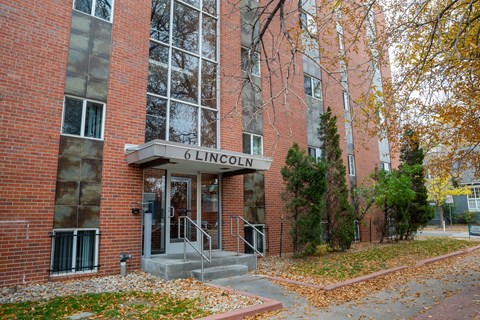 a brick building with a sign in front of it