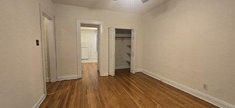 A room with wooden floors and white walls.