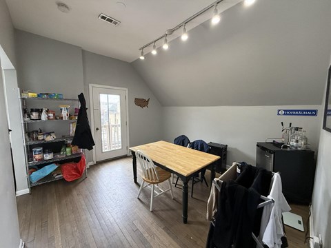 A room with a table and chairs in it.