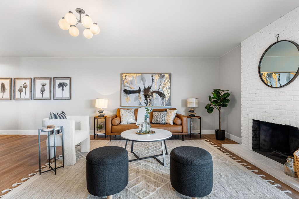 a large open-concept living room with a couch and a table and a fireplace