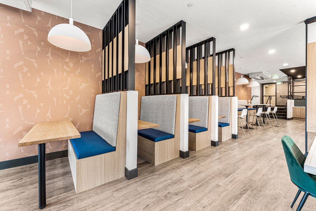 a restaurant with wooden tables and chairs and a partitioned wall