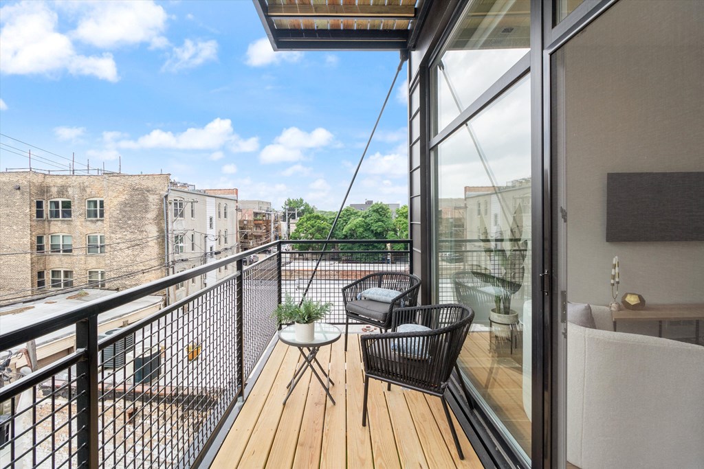 a balcony with a wooden deck and a glass door