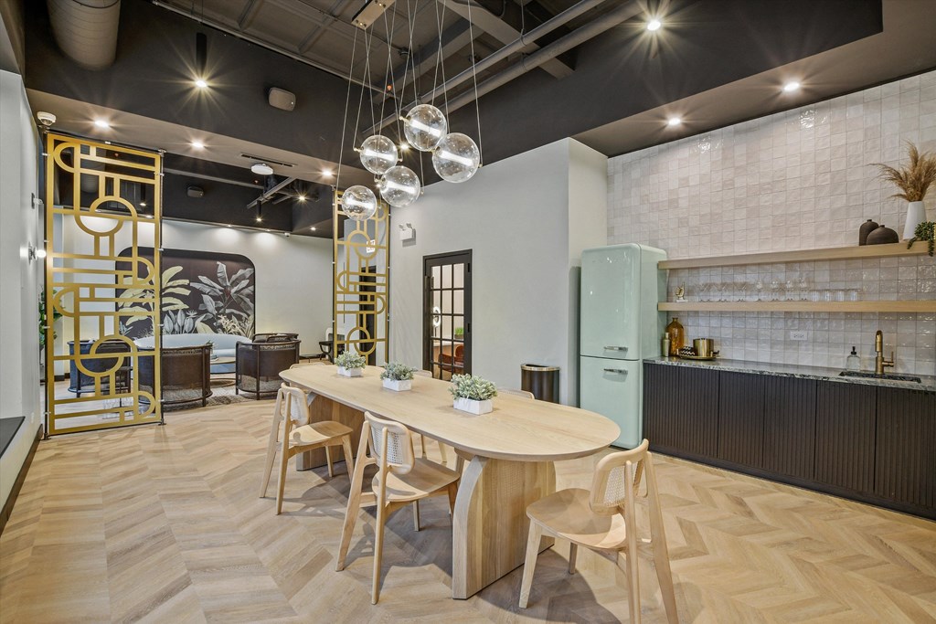 Community room at The Archer featuring a stylish dining area, modern kitchen, and inviting lounge space.