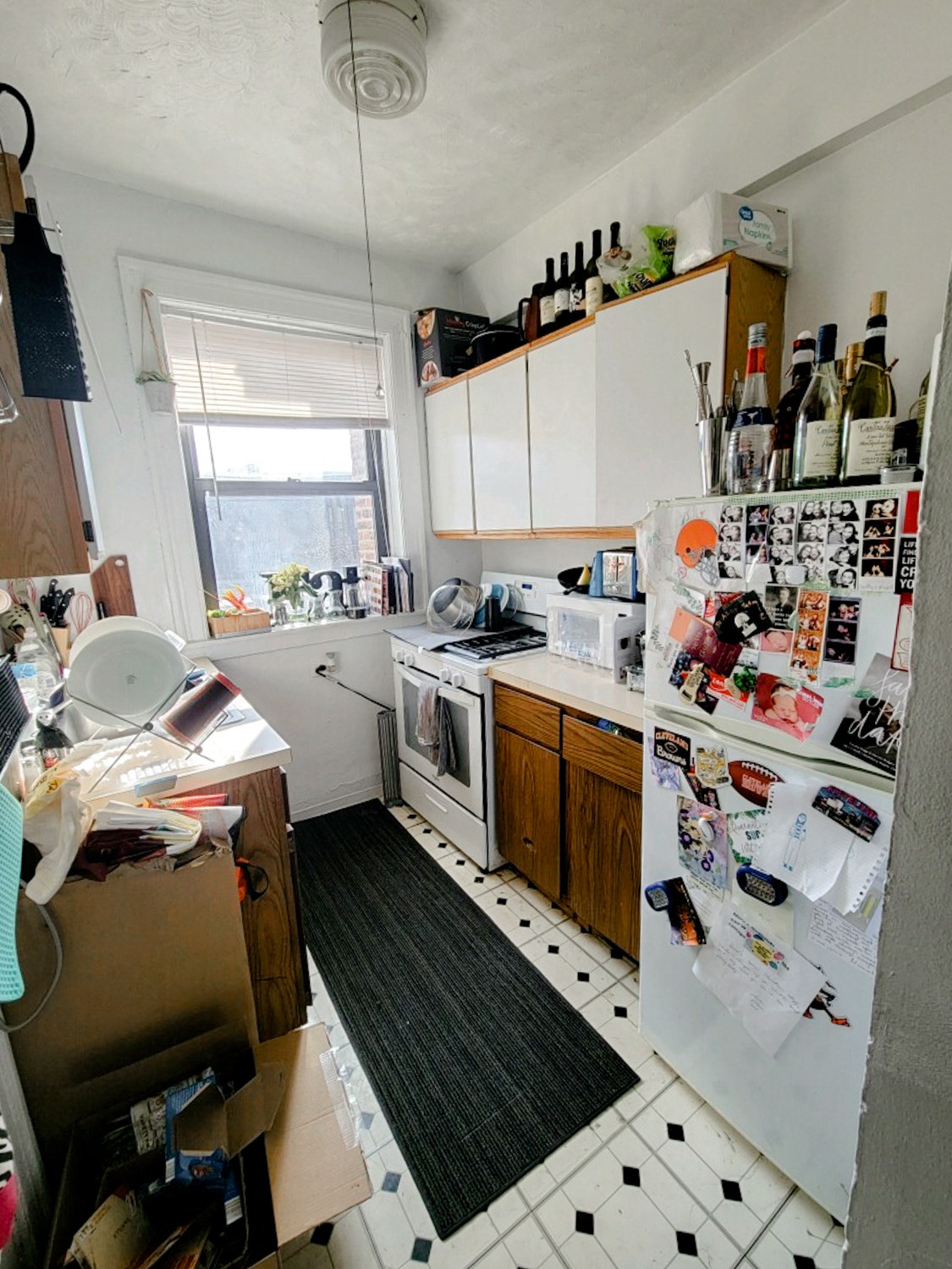 a cluttered kitchen with a refrigerator and a stove
