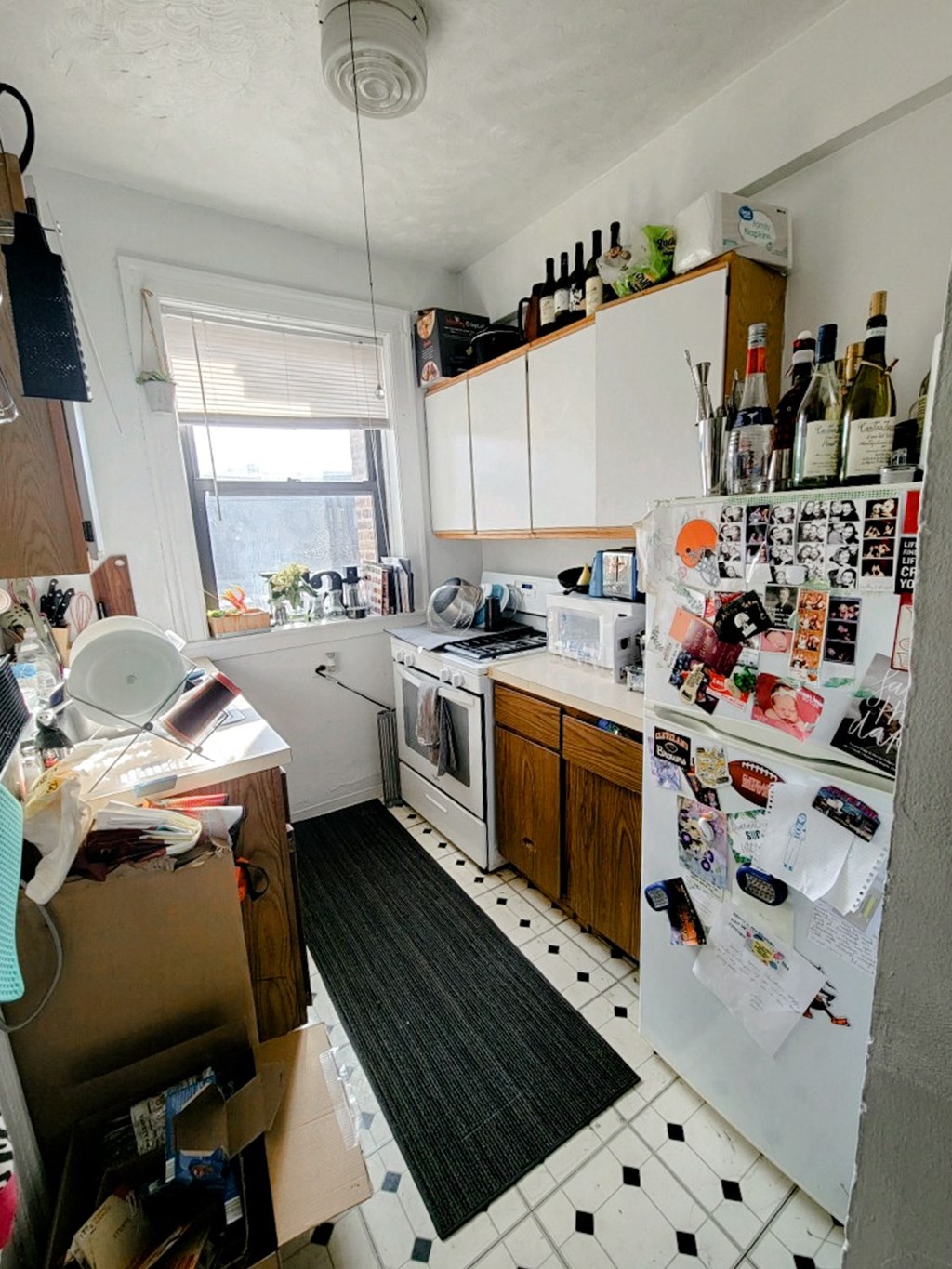 a cluttered kitchen with a refrigerator and a stove