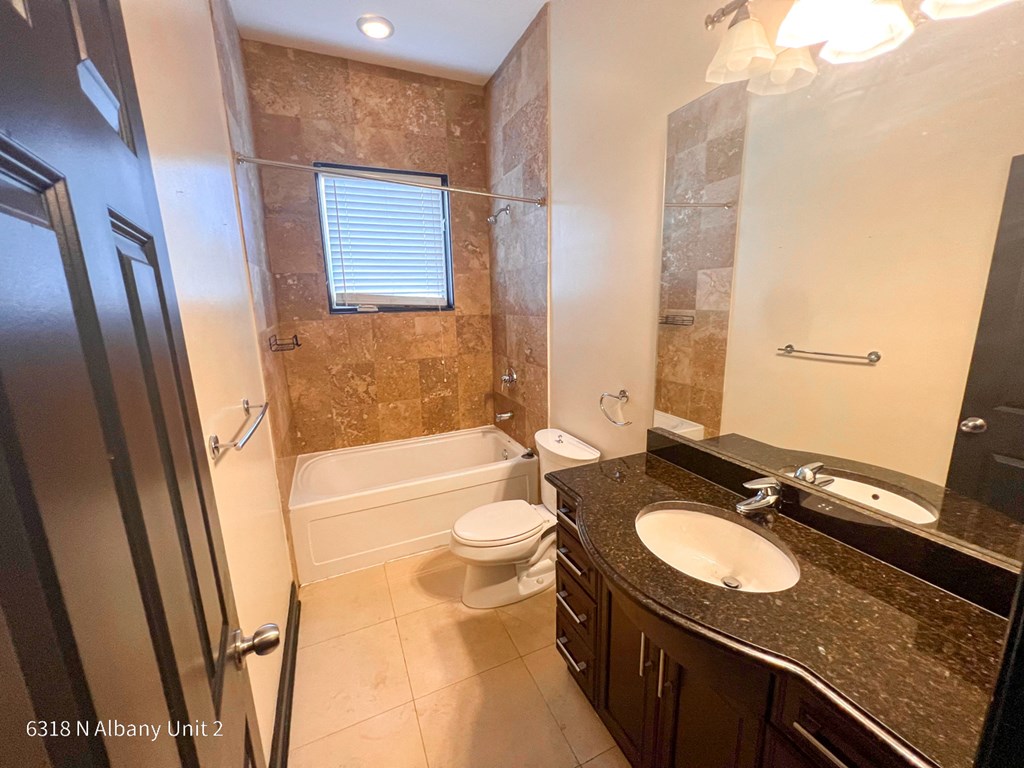 a bathroom with a sink and a toilet and a tub
