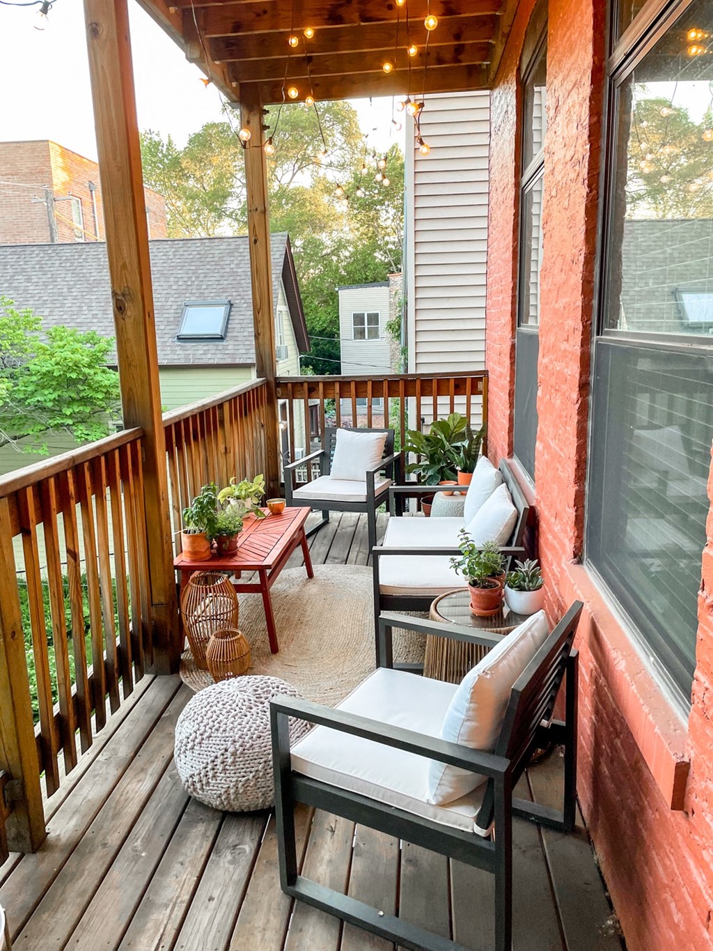 a porch with two chairs and a table on it