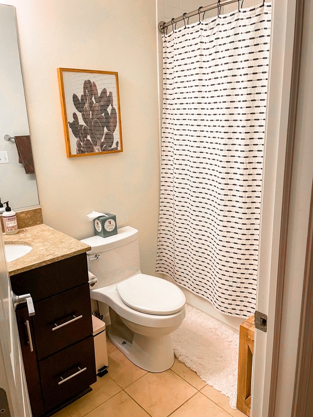 the bathroom has a shower curtain and a toilet