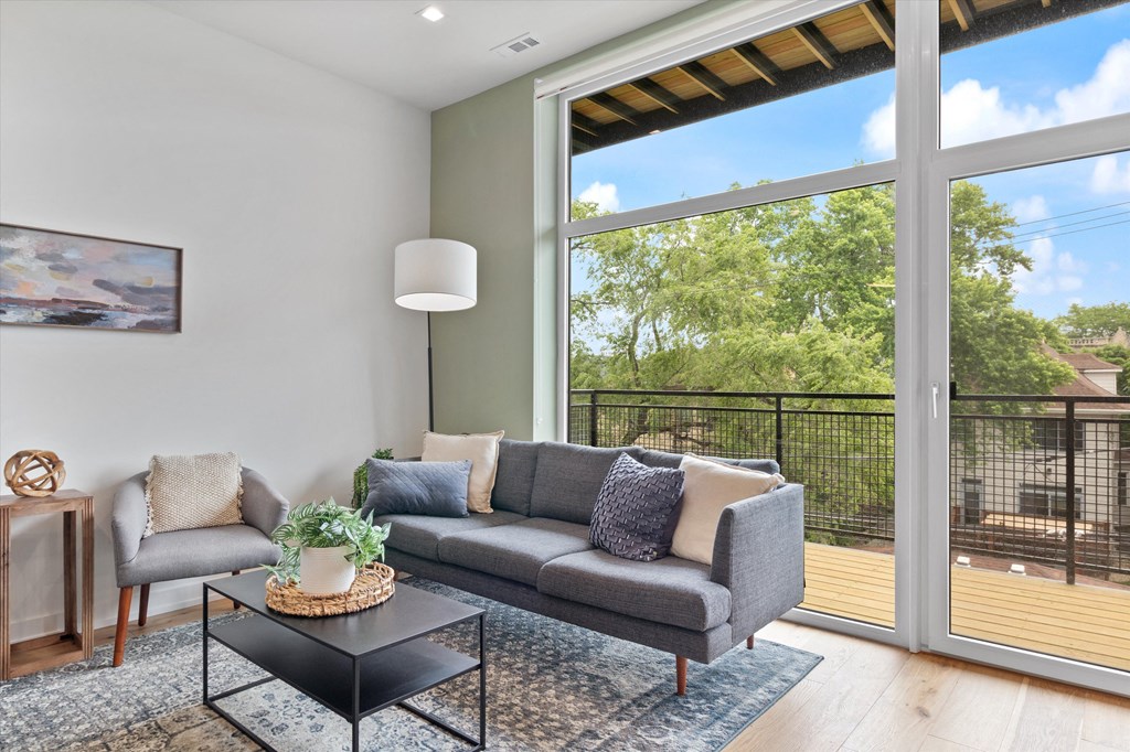 a living room with a couch and a table and a large window