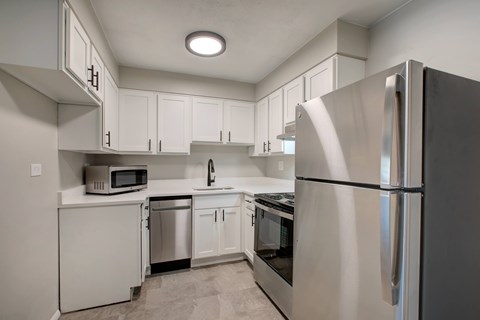 A modern kitchen with a stainless steel refrigerator.