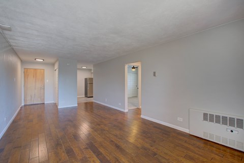 A room with wooden floors and white walls.