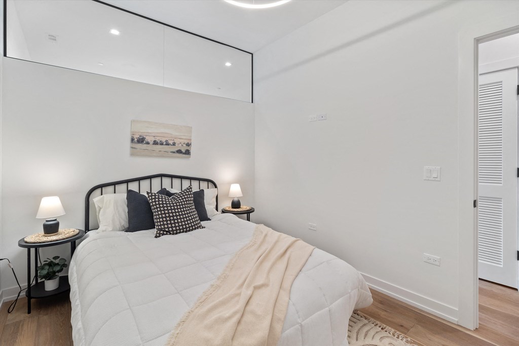 a bedroom with a large bed and a window