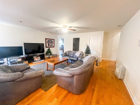 A living room with a television, two couches, and a coffee table.