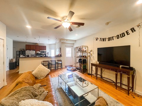 A living room with a brown couch and a flat screen TV.