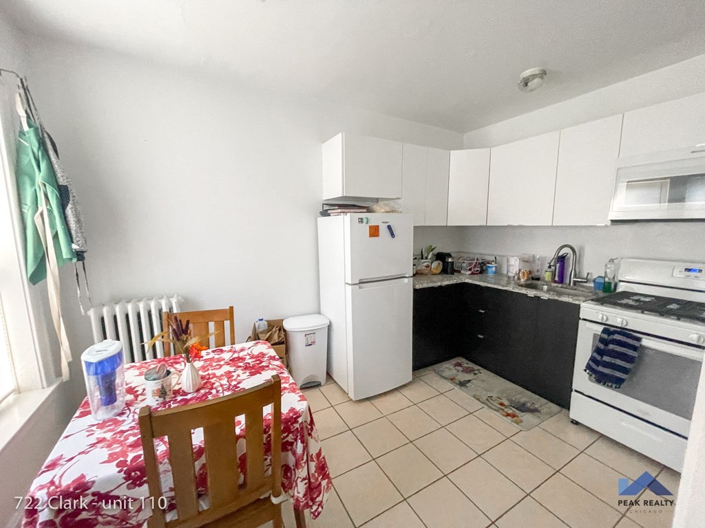 a kitchen with a table and a refrigerator