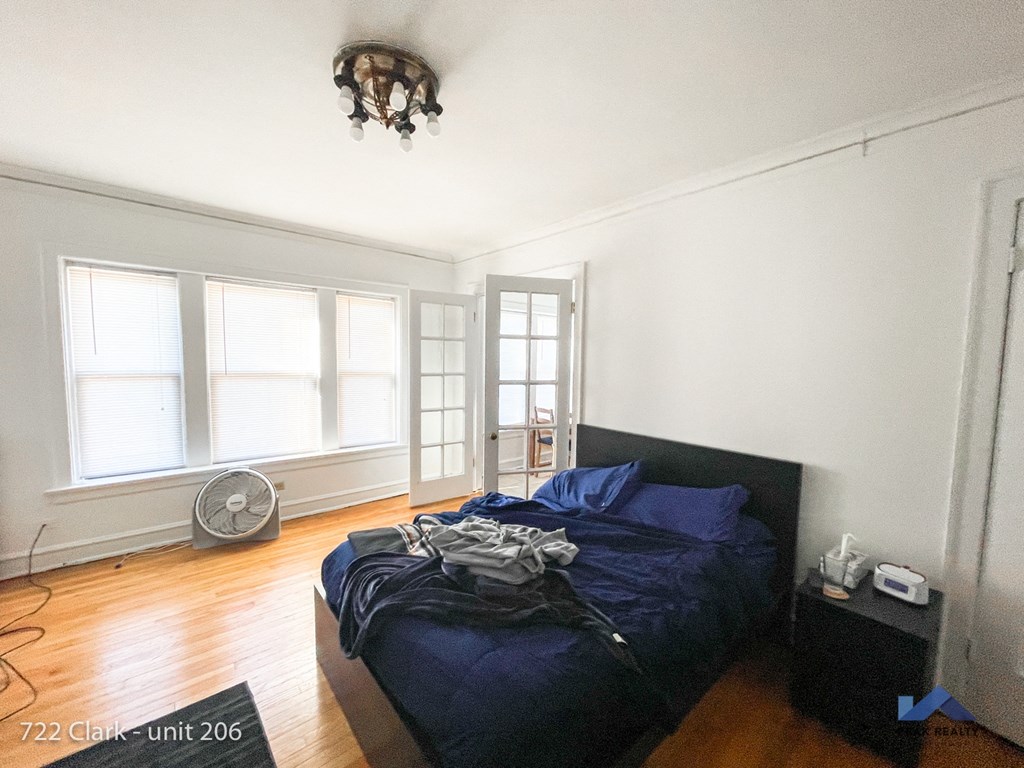 a bedroom with a bed and a chandelier