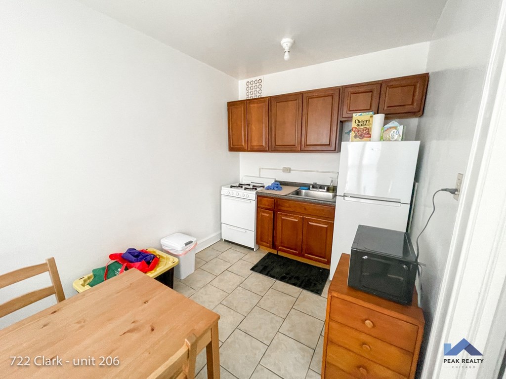 a small kitchen with a table and a refrigerator