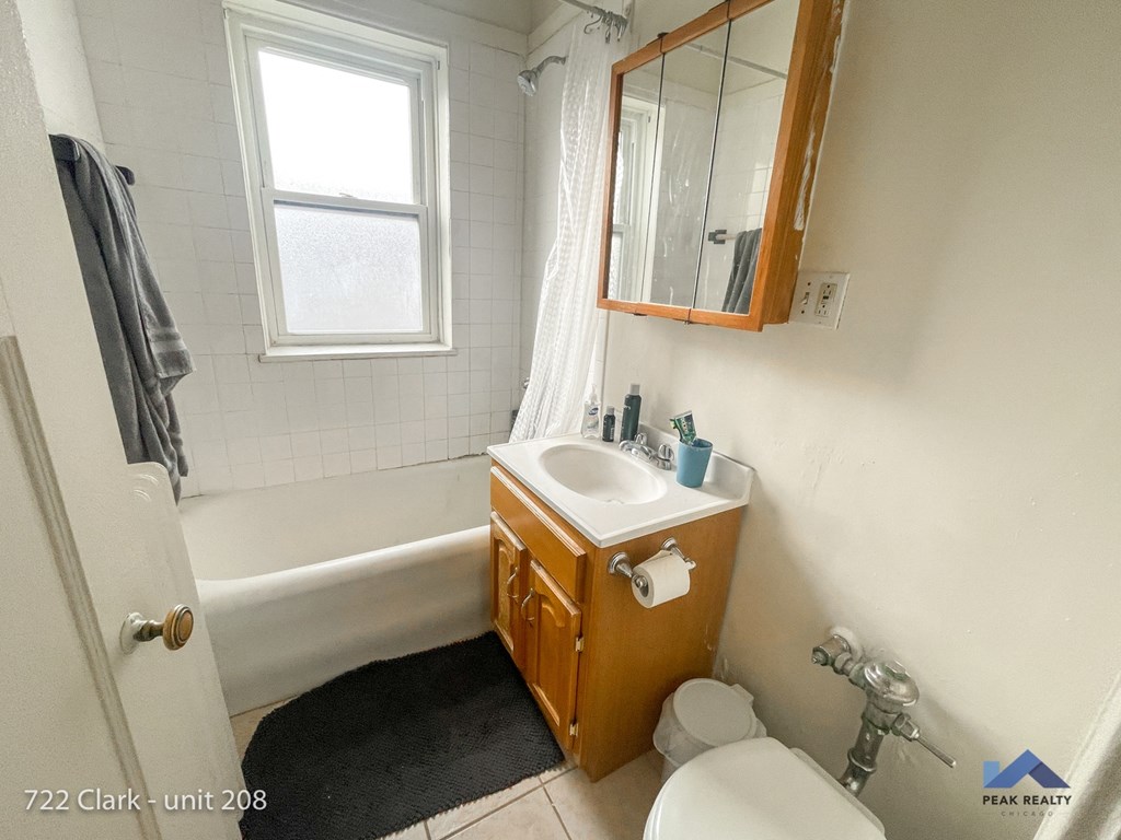 a small bathroom with a sink toilet and bath tub