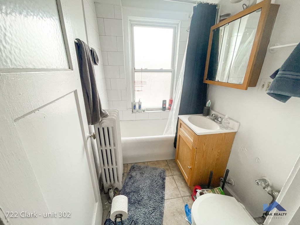 a small bathroom with a sink toilet and bath tub