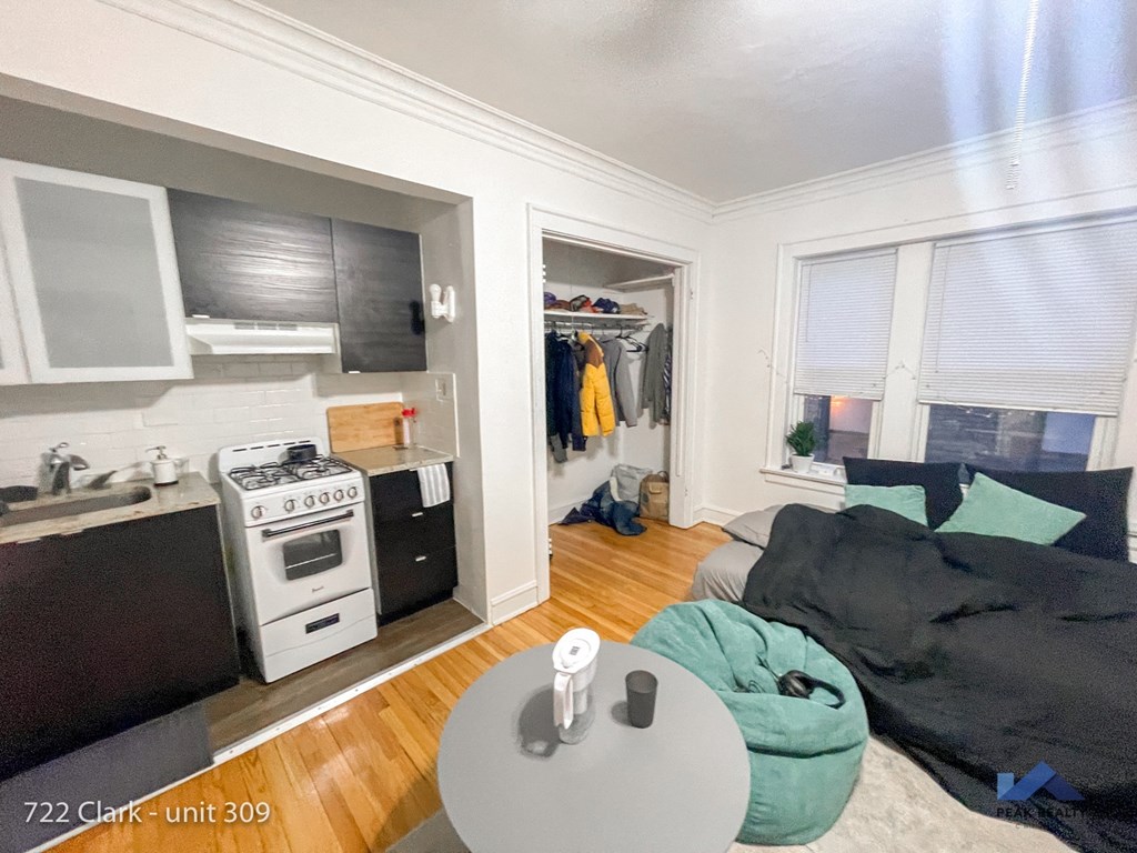 a living room with a kitchen and a couch and a table