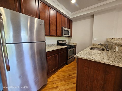 a kitchen with stainless steel appliances and granite counter tops