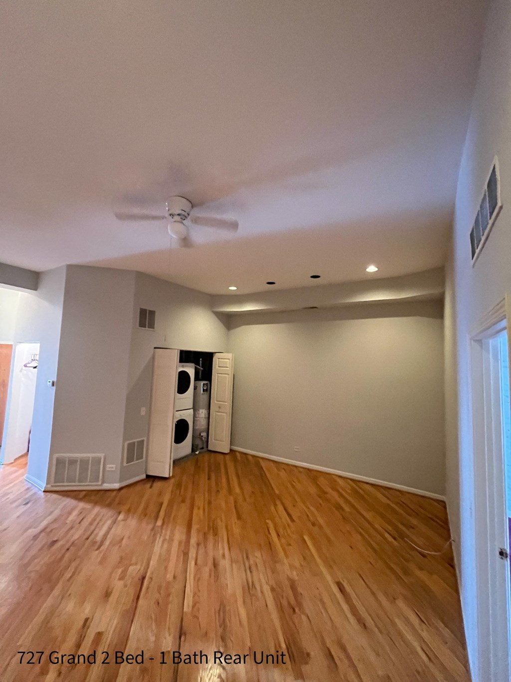 a look at the living room with hardwood floors and a ceiling fan