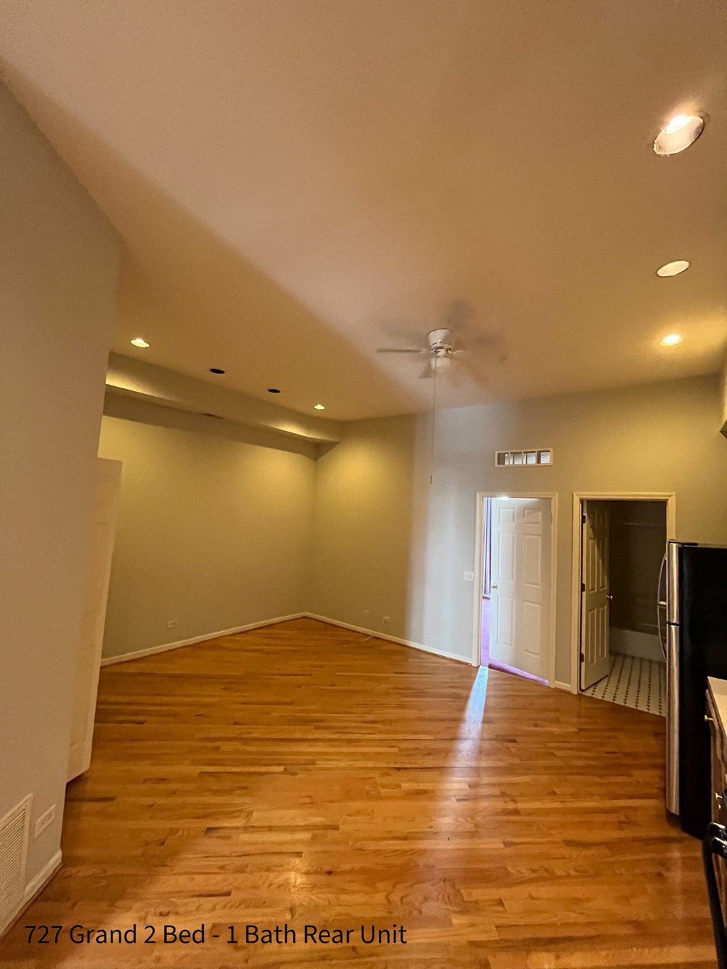 a living room with hardwood floors and a ceiling fan