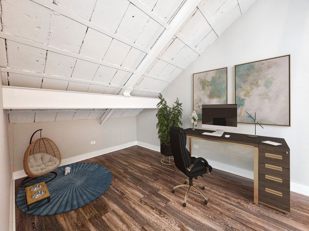 an attic office with a desk and a chair