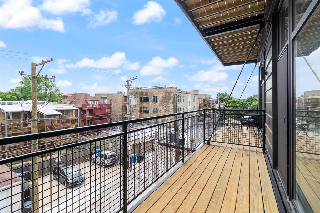 a balcony with a wood deck and a view of the city
