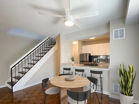 A modern kitchen with a dining table and chairs.