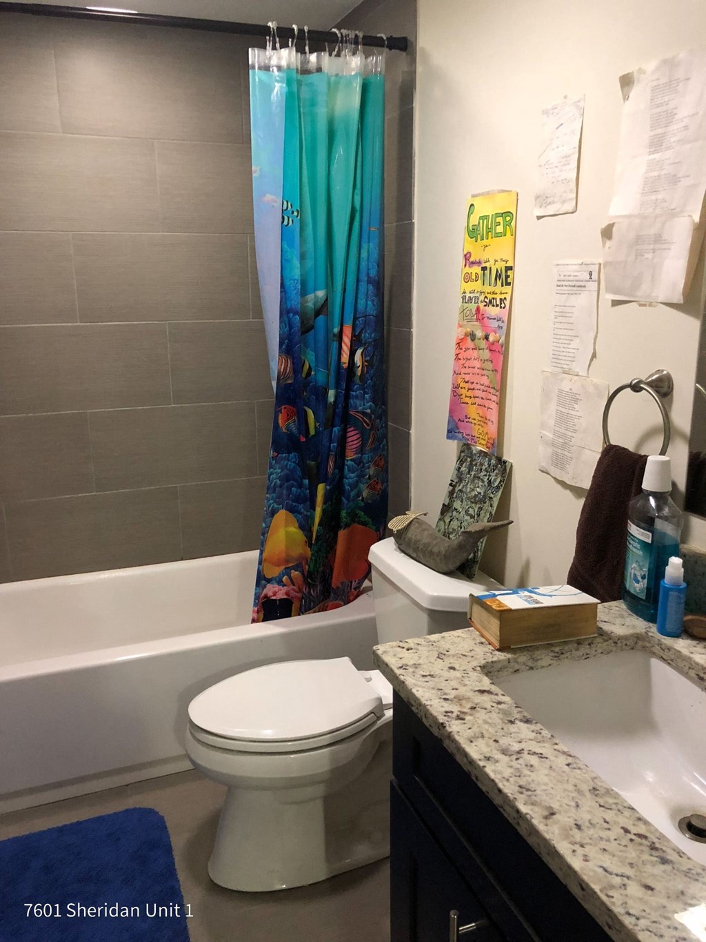 a bathroom with a toilet and a sink and a bath tub