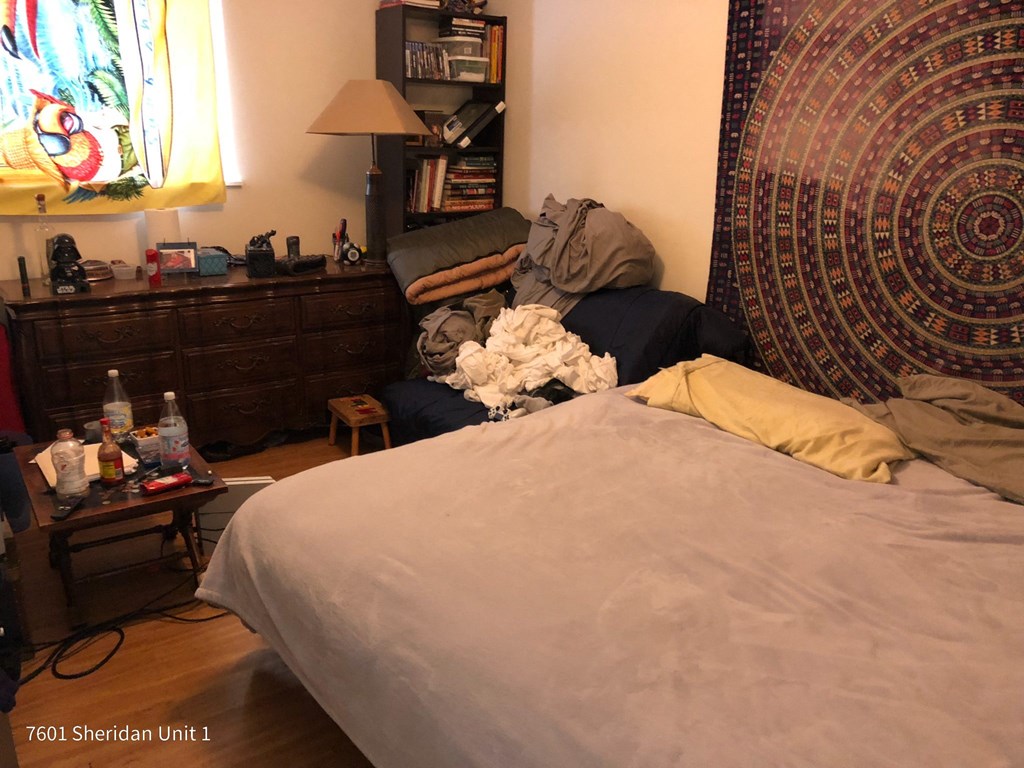 a messy bedroom with a bed and a dresser