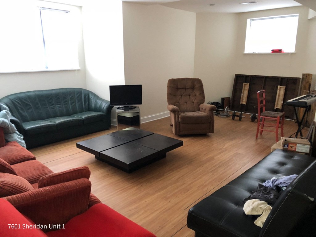 a living room with couches and chairs and a television