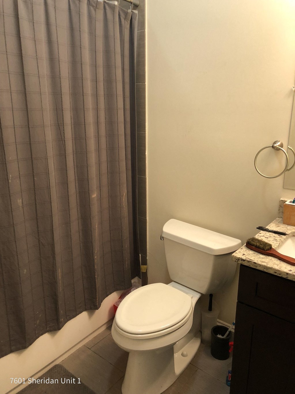 a bathroom with a toilet and a shower curtain