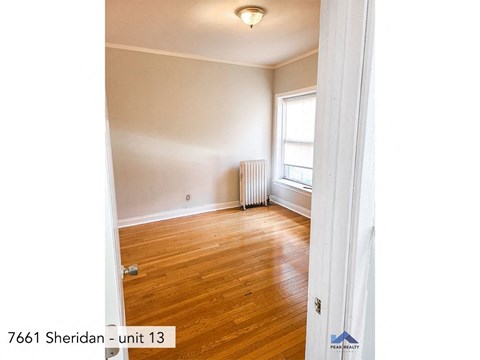 the living room of an empty house with a wood floor